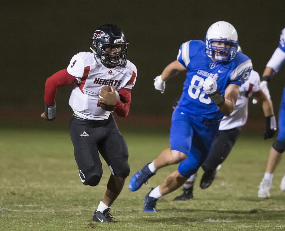 Heights quarterback K’Vonte Baker heads upfield in the first half against Kapaun. 