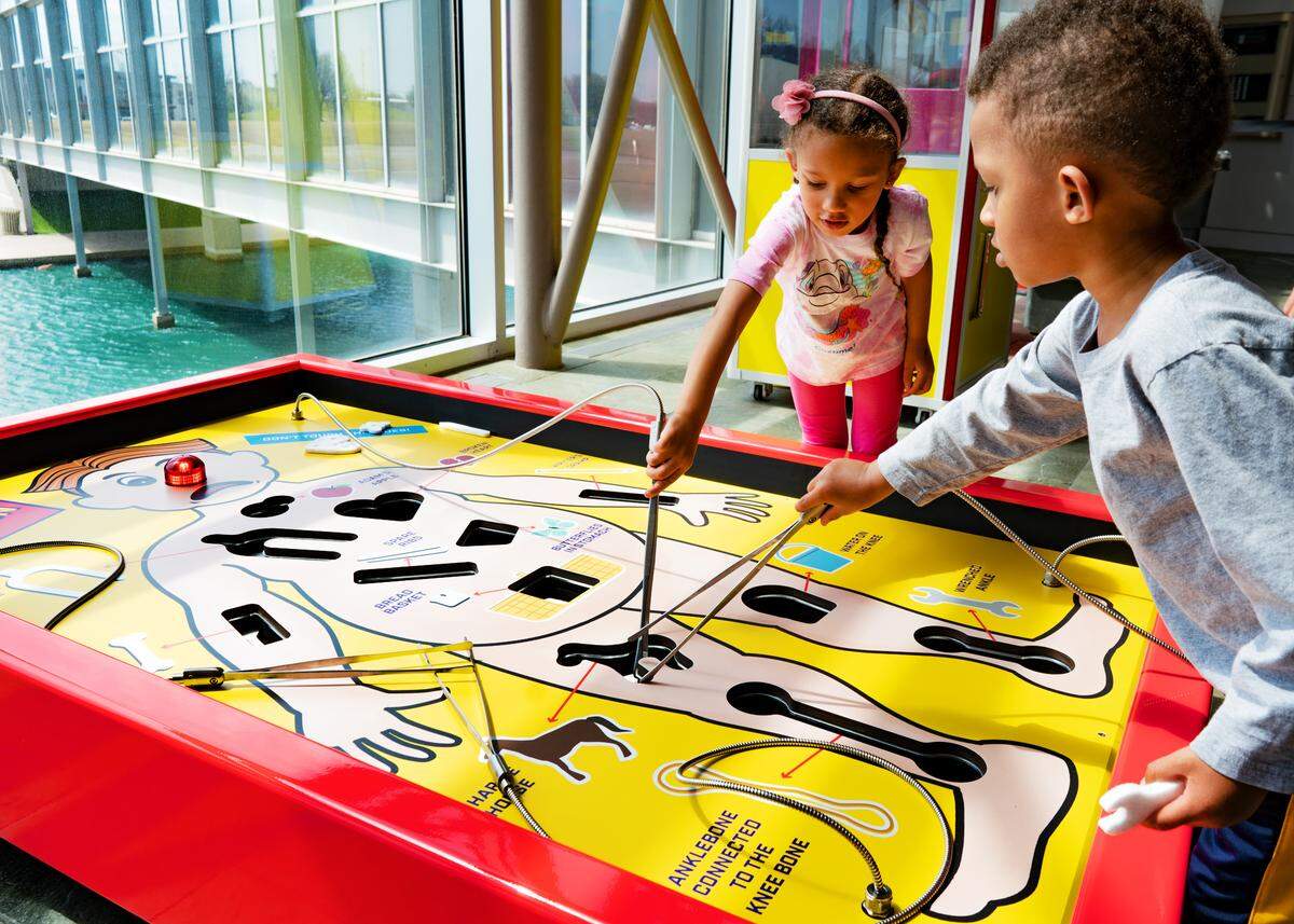 Health Inside Out, Exploration Place’s new permanent display, lets visitors try their skilled hands at an oversized Operation game.