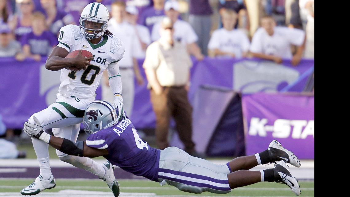 K-State Wildcats linebacker Arthur Brown (4) stretches out to stop Baylor Bears quarterback Robert Griffin III (10) in the final few plays of the 4th quarter.  Griffin was held on 4th down then turned the ball over to K-State. (Oct 1, 2011)