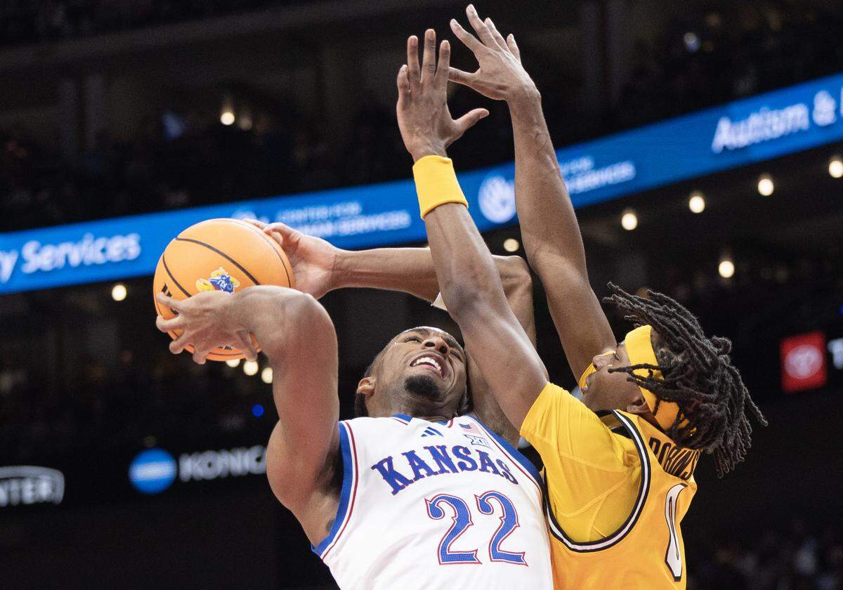 Kansas’ Darryn Peterson goes up for a shot against Missouri’s Anthony Robinson II during the first half of their game at T-Mobile Center on Sunday, Dec. 7, 2025