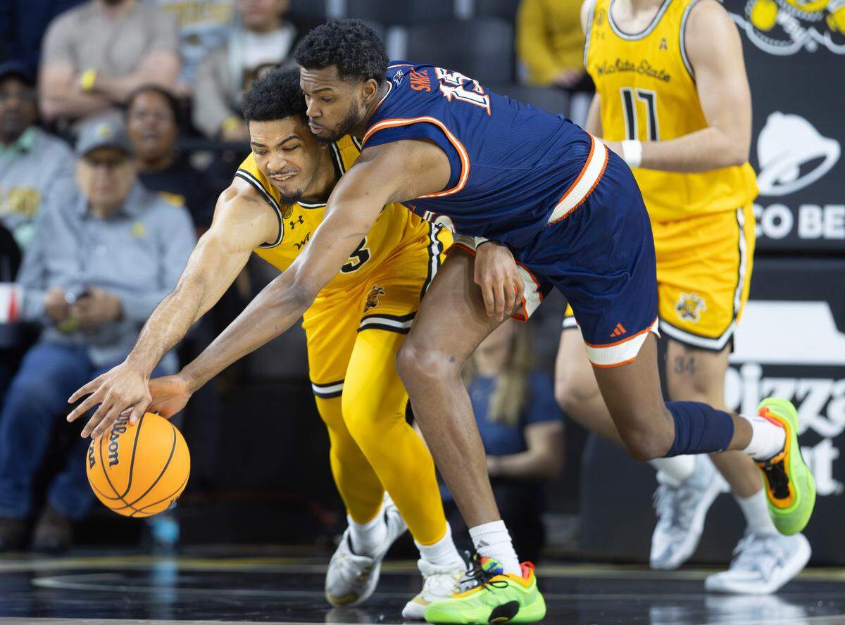 Wichita State’s Ronnie DeGray III fights for a loose ball against UTSA’s Jonnivius Smith during the first half of their game at Koch Arena on Wednesday. 