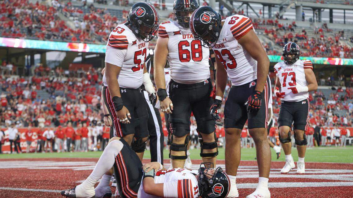 Utah Utes quarterback Isaac Wilson (11) holds his arm after an apparent injury during the second quarter against the Houston Cougars at TDECU Stadium.