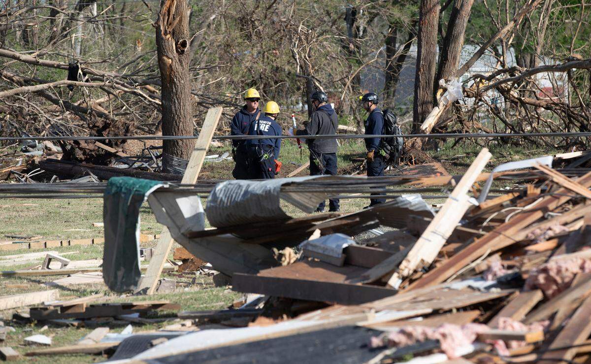 Wichita firefighters search an area north of the Andover YMCA after a tornado hit it on April 29, 2022. (April 30, 2022)