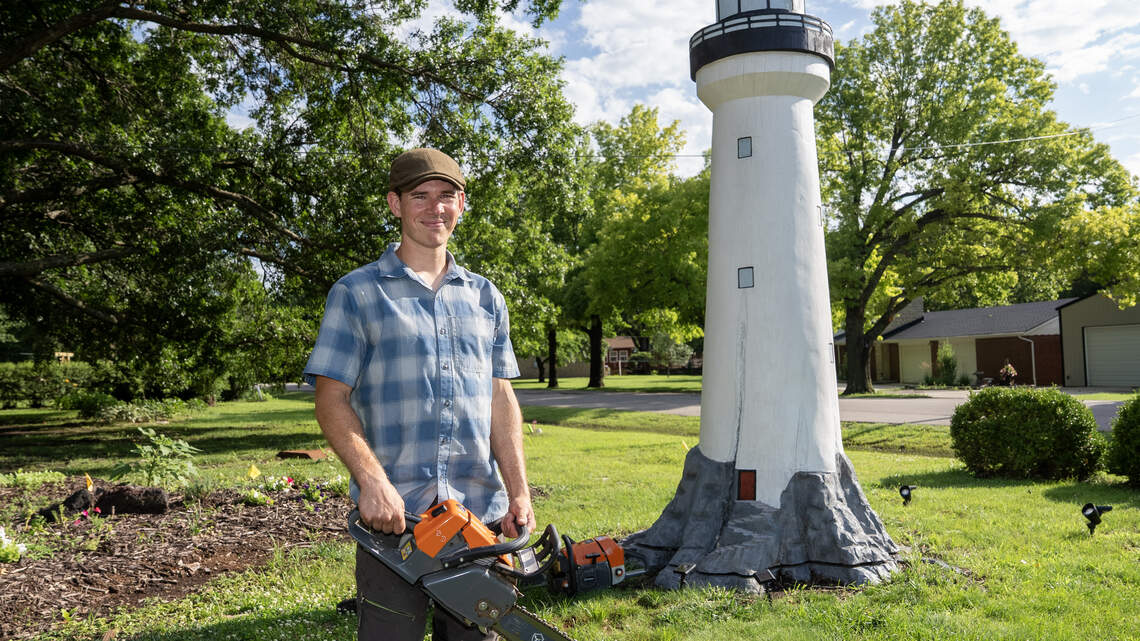 He was hired to remove an Andover oak tree. He ended up carving a lighthouse and an owl