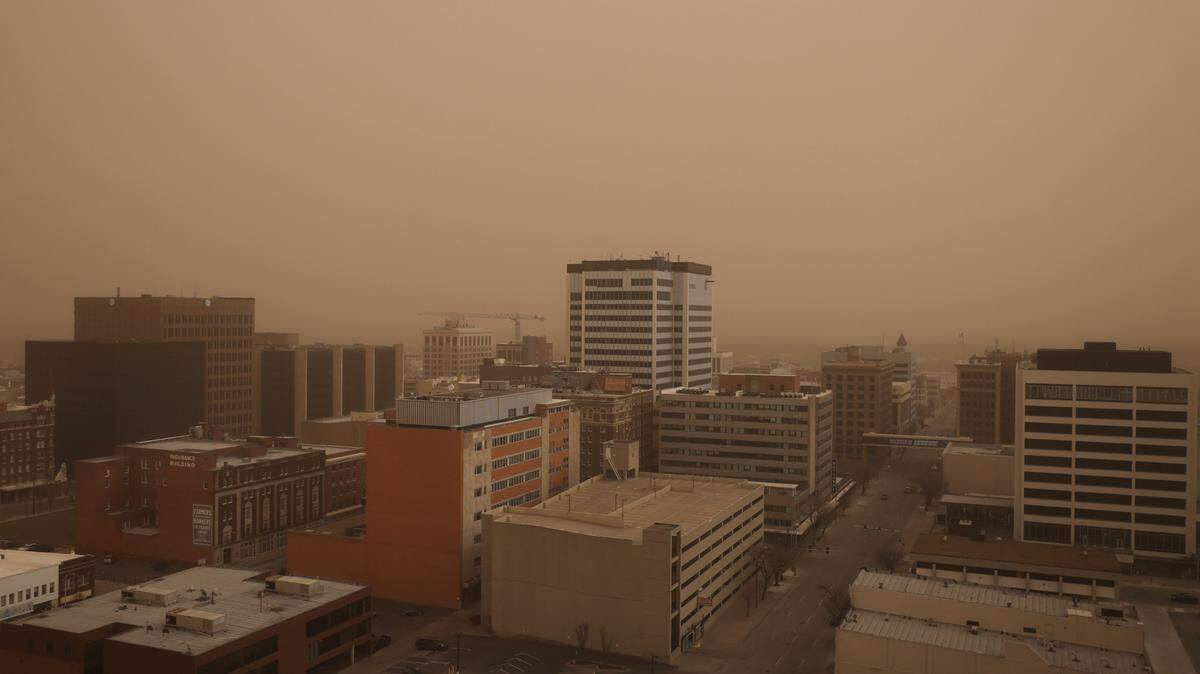 A cloud of dust envelopes Wichita as dust and smoke blows across the southern plains on Friday.