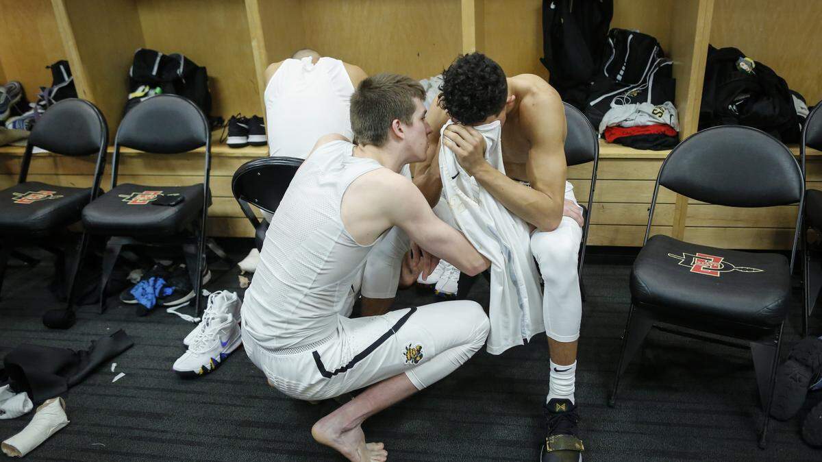 Wichita State's Landry Shamet is consoled by teammate Austin Reaves after the Shockers fell 81-75 to Marshall in the first round of the NCAA Tournament.