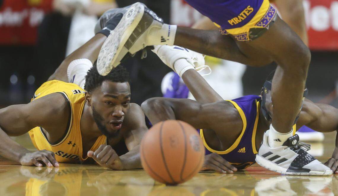 Wichita State forward Markis McDuffie scrambles for a loose ball against East Carolina guard Addison Hill during the first half of their game at Koch Arena on Tuesday.