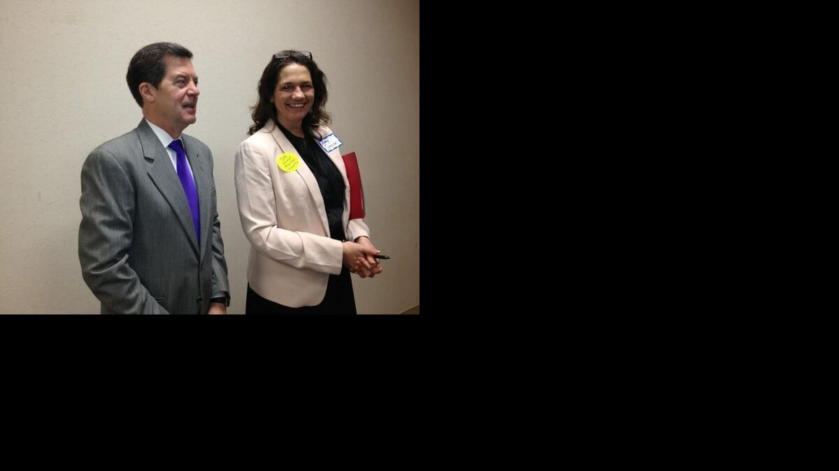 Gov. Sam Brownback, left, thanks the crowd for their advocacy on mental health issues in Topeka.

