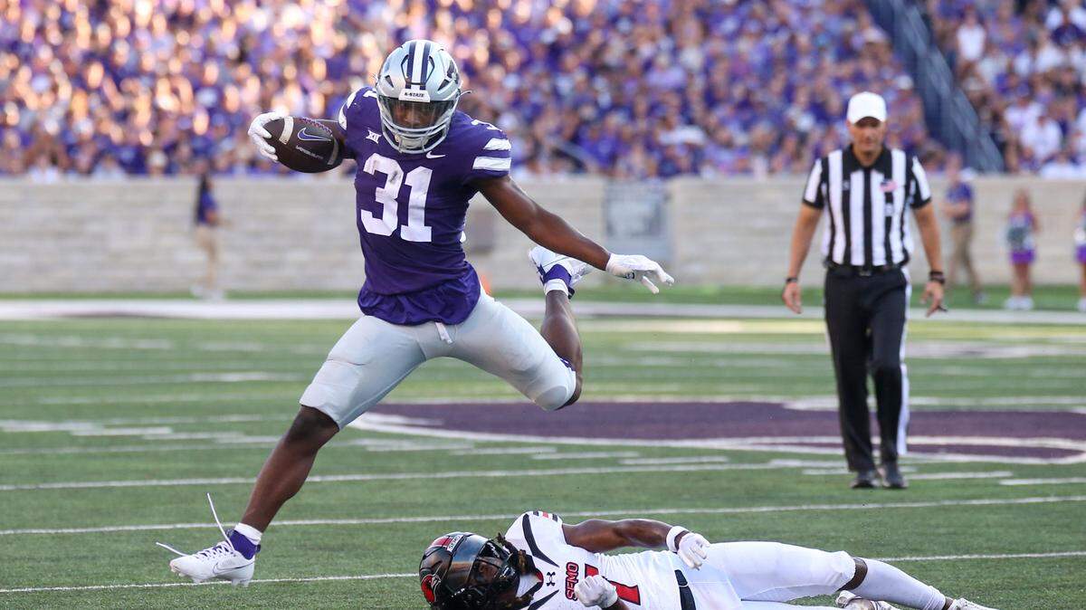 Kansas State Wildcats running back DJ Giddens (31) jumps over Southeast Missouri State Redhawks defensive back Lawrence Johnson (7) during the first quarter at Bill Snyder Family Football Stadium on Sept. 2, 2023.