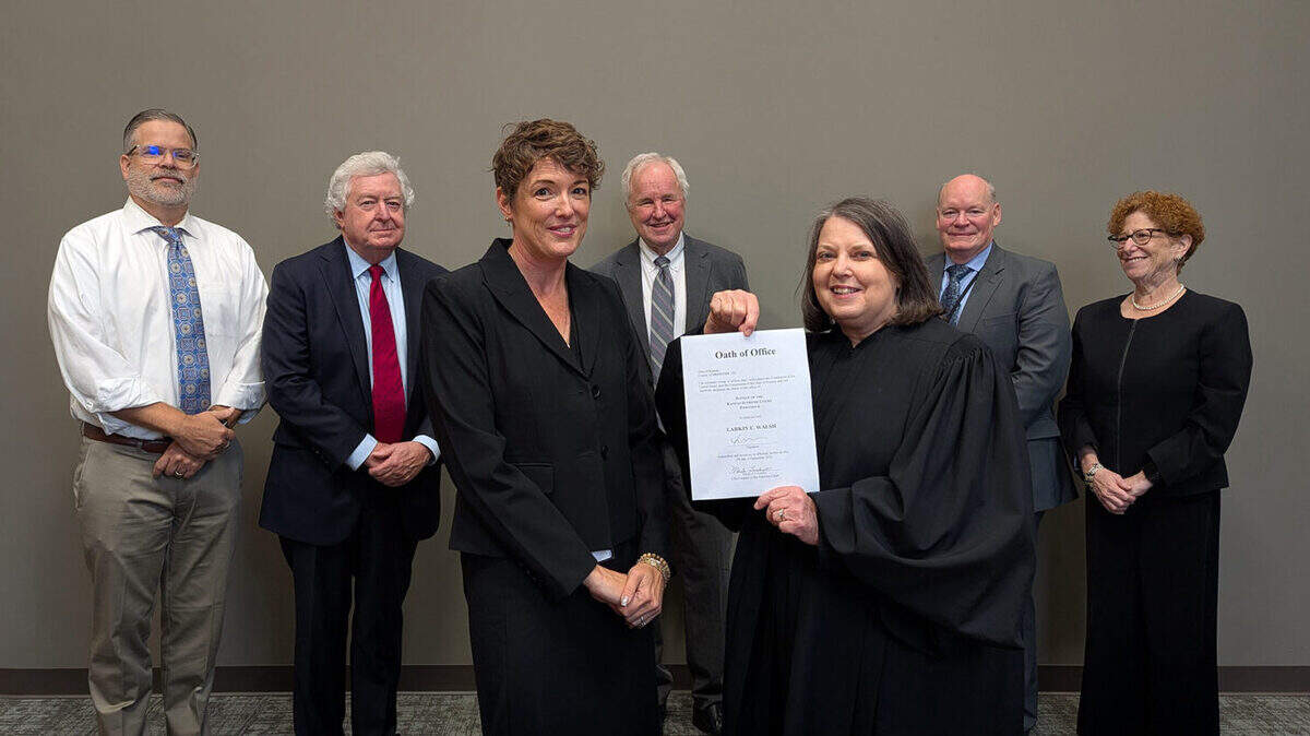 Larkin Walsh, front left, is the Kansas Supreme Court’s newest justice after an informal swearing in ceremony on Wednesday in Topeka.