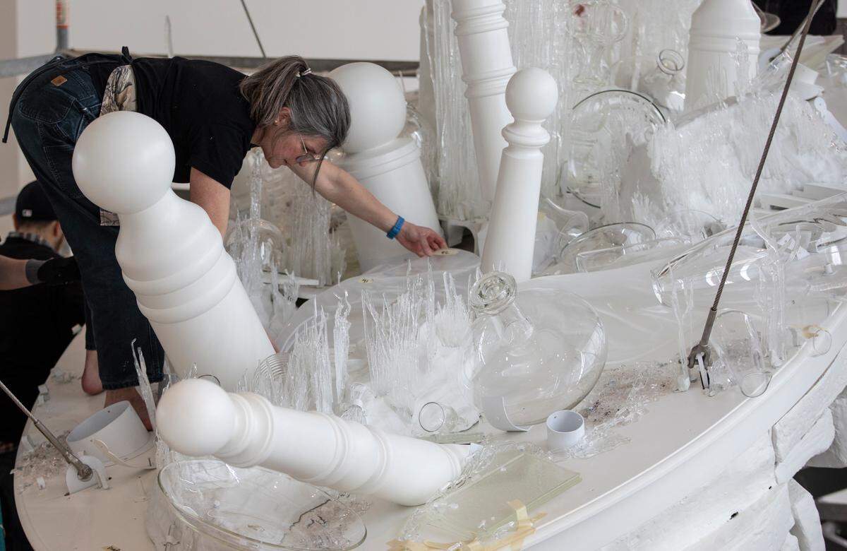 Artist Beth Lipman helps install her new large-scale public sculpture, Living History, in the entry of the Wichita Art Museum this week. The sculpture was made specifically for the Wichita Art Museum and references the history, ecology, and culture of Wichita and surrounding areas. It recreates plants, grasses, and rock formations found in the nearby Flint Hills. Living History also nods to iconic artwork in the museum’s collection, including barber poles from WAM’s Americana collection and vertical forms from artist Louise Nevelson’s Night Sun III sculpture. Lipman has work n the collections of the Brooklyn Museum, Corning Museum of Glass, Detroit Institute of Arts, and the Smithsonian American Art Museum