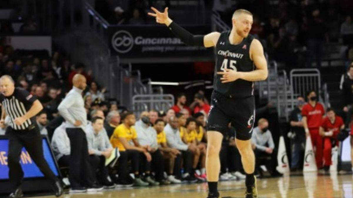 Mason Madsen celebrates one of Cincinnati’s 11 three-pointers it made in an 85-76 win over Wichita State at Fifth Third Arena on Thursday.
