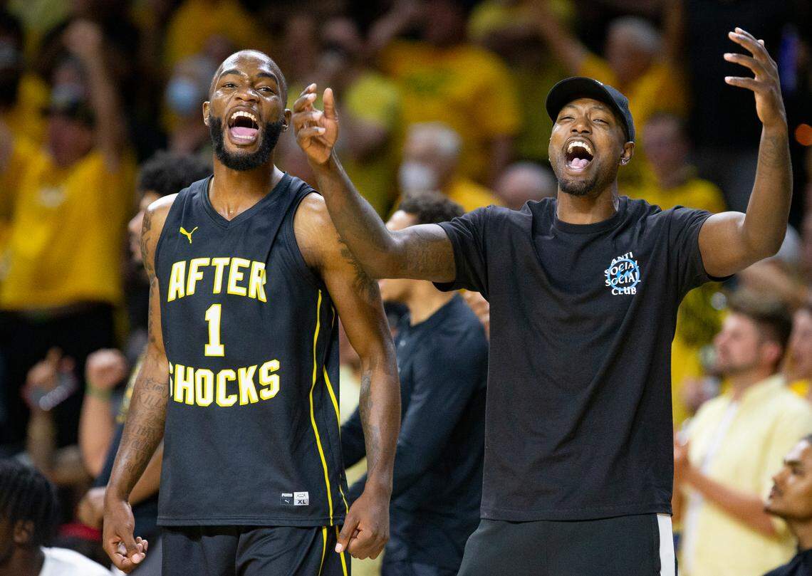 Markis McDuffie (left) and Zach Brown (right) celebrate during the AfterShocks’ 74-67 win over Gutter Cat Gang at Koch Arena on Wednesday.