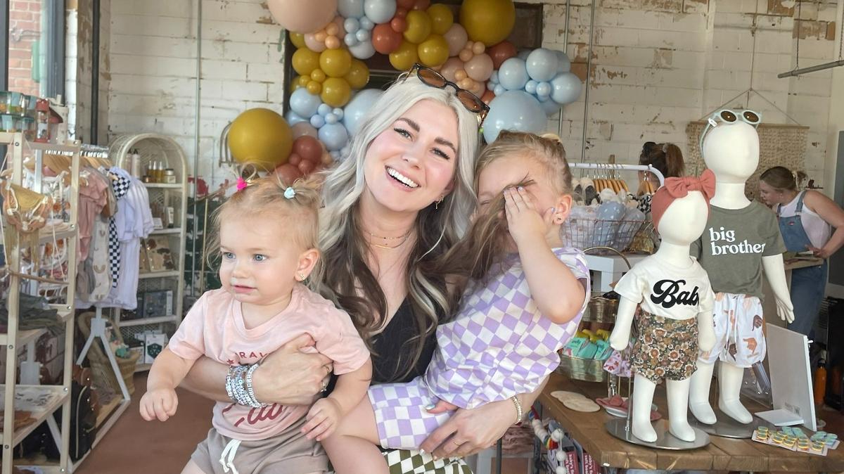 Juliana Cavender with her children, Honor, left, and Worthy, in her Mini Co. shop when it was still at the Garage at Cleveland Corner incubator space. She’s now moved the store to permanent space at Clifton Square near her other businesses.