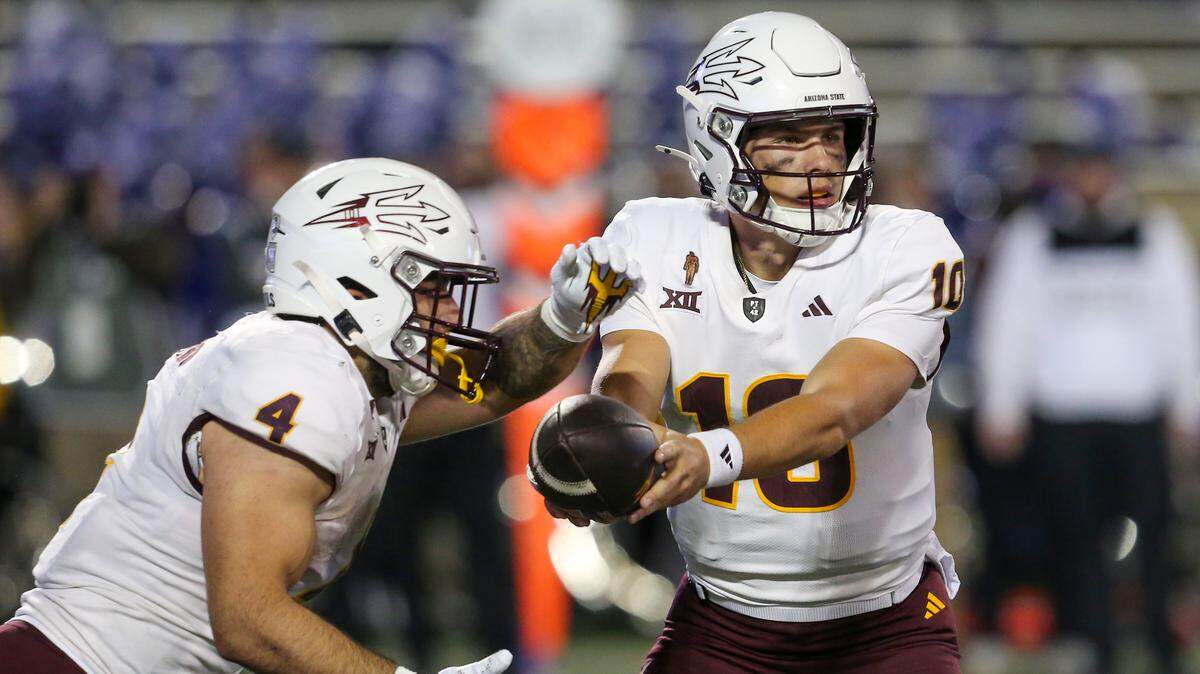 Arizona State Sun Devils quarterback Sam Leavitt (10) hands off to running back Cam Skattebo (4) against the Kansas State Wildcats during the second quarter at Bill Snyder Family Football Stadium.