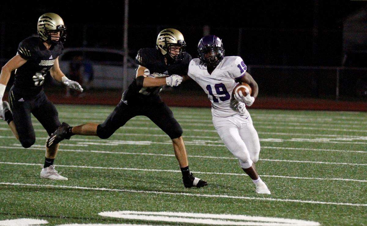 Valley Center senior running back Larry Wilson holds off an Andover Central tackler in the Hornets’ 27-17 loss on Thursday. (Sept. 20, 2018)