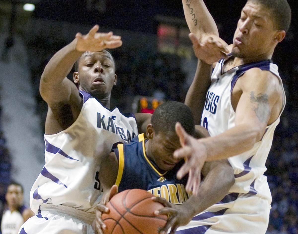 Kansas State guard Jacob Pullen, left, and Michael Beasley,right, trap  California guard Nican Robinson during the first half ofa college basketball  game on Sunday Dec. 9, 2007, in Manhattan, Kan.(AP Photo/Christopher  Hanewinckel)