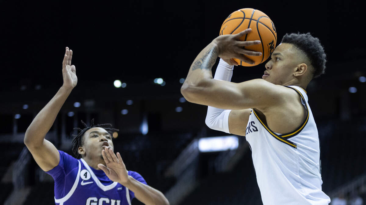 Wichita State’s Xavier Bell shoots a three-pointer over Grand Canyon University’s Kobe Knox during the second half of their semi-final game of the Hall of Fame Classic in Kansas City on Monday.
