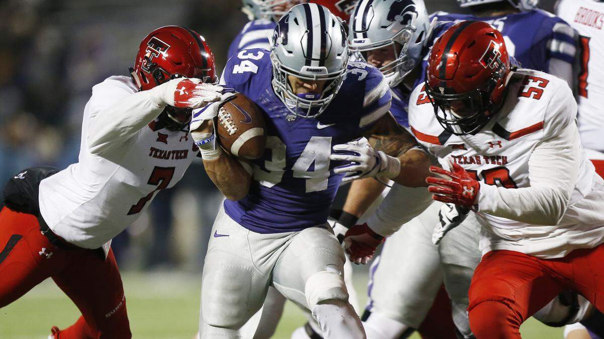 K-State running back Alex Barnes (34) fights his way through Texas Tech defenders near the goal line Saturday in Manhattan. (November 17, 2018)