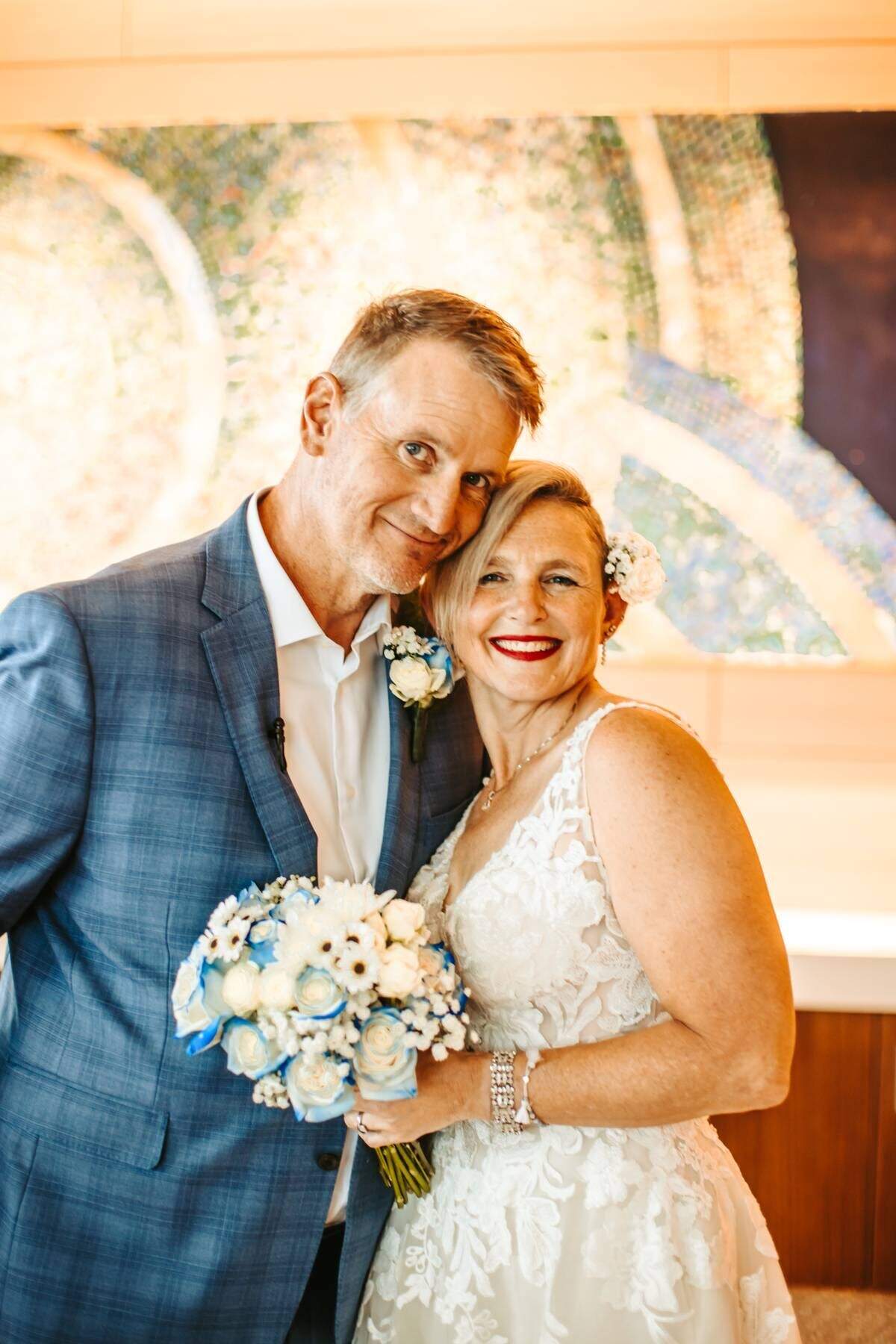 Tracy Anderson and John Bartel pose for a photo after their wedding
