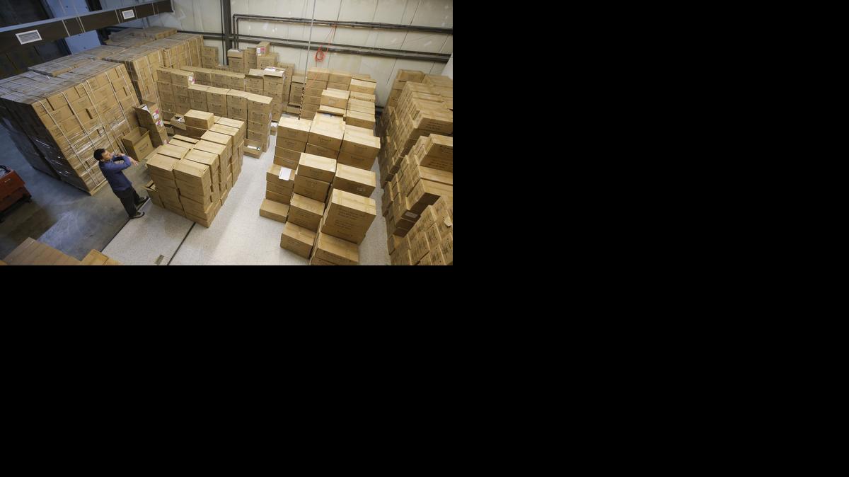Yeow Ng stands among boxes filled with millions of colored rubber bands at the Rainbow Loom online warehouse in northeast Wichita. Ng and his brother Choon, both former Wichita State students, created the toy that has become wildly popular and inspired several copycat versions.

