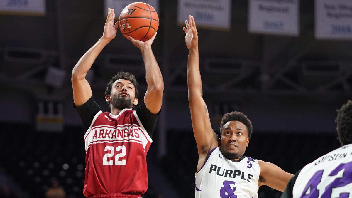 Kamau Stokes (right) tries to make a play on defense against Team Arkansas for Kansas State’s alumni team at The Basketball Tournament inside Koch Arena on Friday, July 21, 2023.