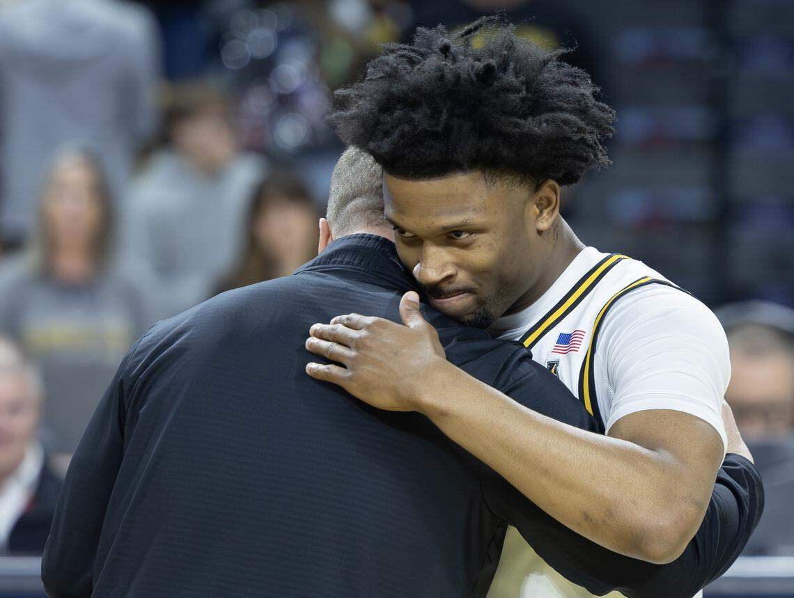 Wichita State’s Kenyon Giles hugs head coach Paul Mills during senior day recognition before Wichita State’s game against Florida Atlantic on Saturday.