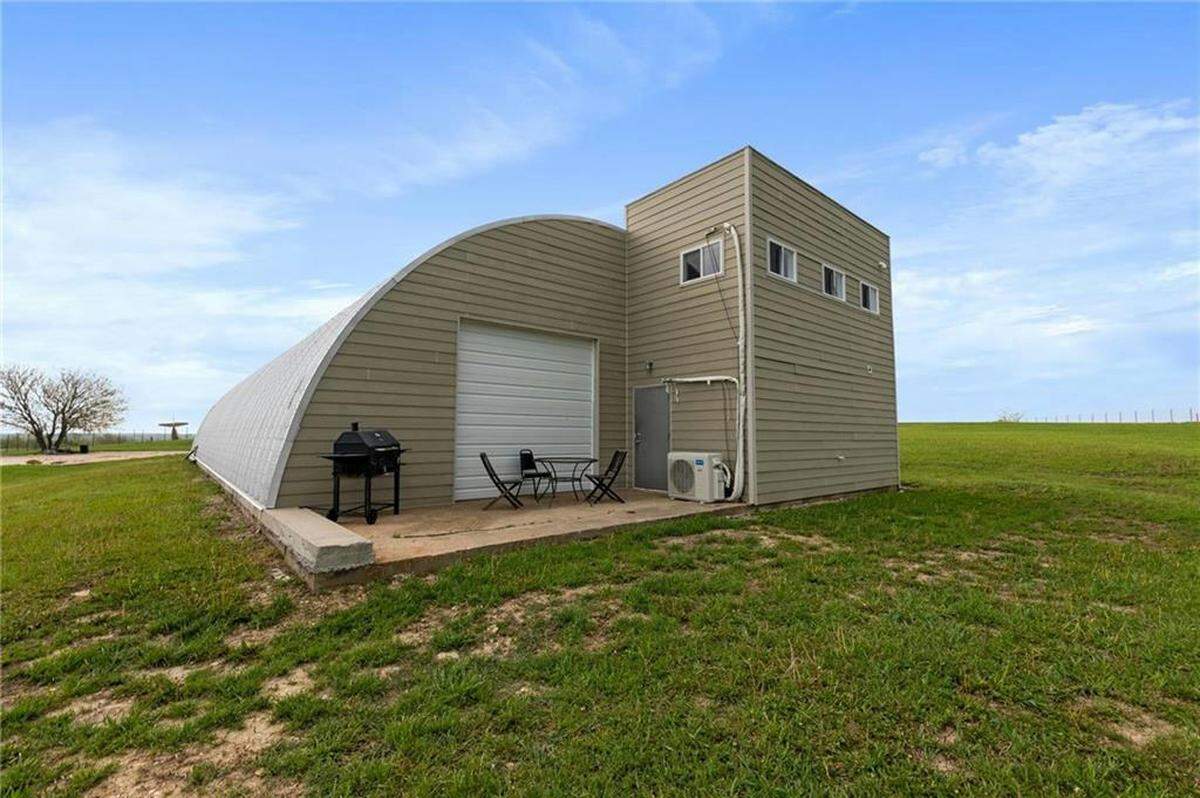 Inside the quonset hut, there’s a garage and some modern living space.