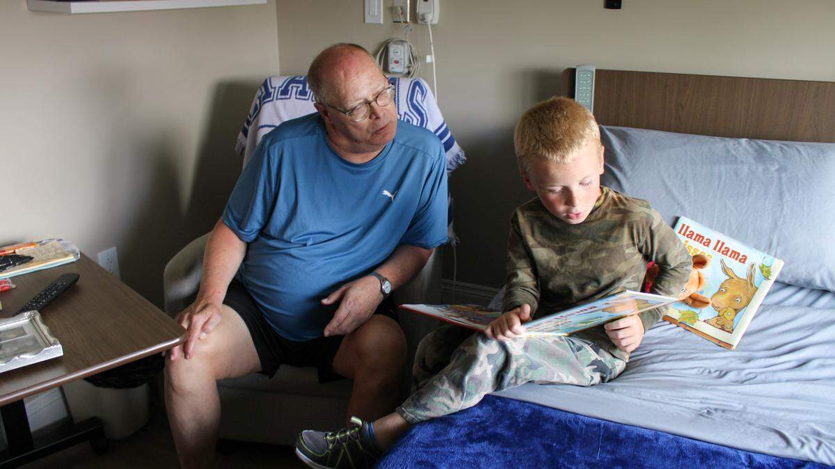 Tom Goscha, 63, and Rhett, 6, read together at the Logan Intergenerational Family Education Center in Logan, Kansas.