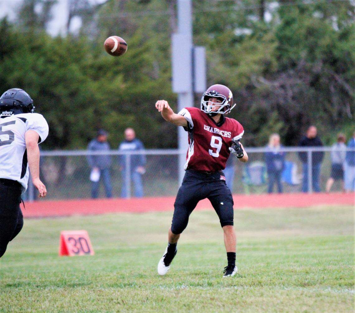 Burrton junior quarterback Leif Hernandez floats a pass over an oncoming Fowler defender during the Chargers’ 71-34 home win Friday.