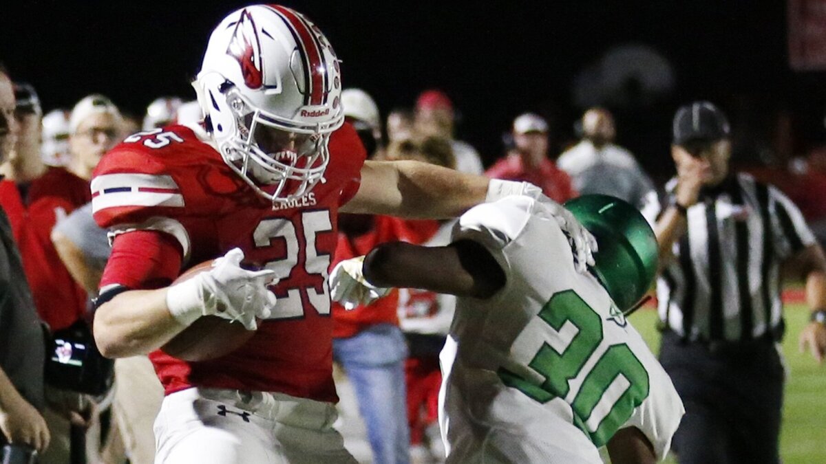 Maize running back #25 Caden Cox is hit late by Derby defender # 30 Terry Ginyard.  Derby was penalized for the hit Friday night in Maize. (October 19, 2018)