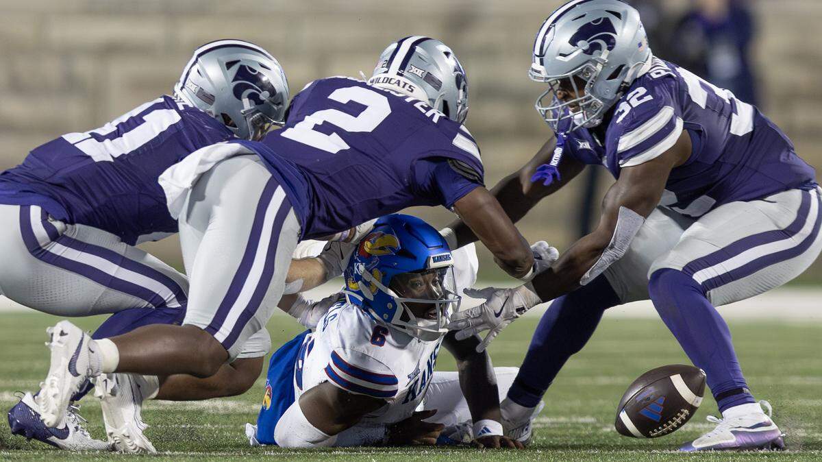 Kansas quarterback Jalon Daniels fumbles the ball during the fourth quarter of their game against Kansas State on Saturday night at Bill Snyder Family Stadium. The fumble led to a Kansas State field goal and a 29-27 victory for Kansas State.