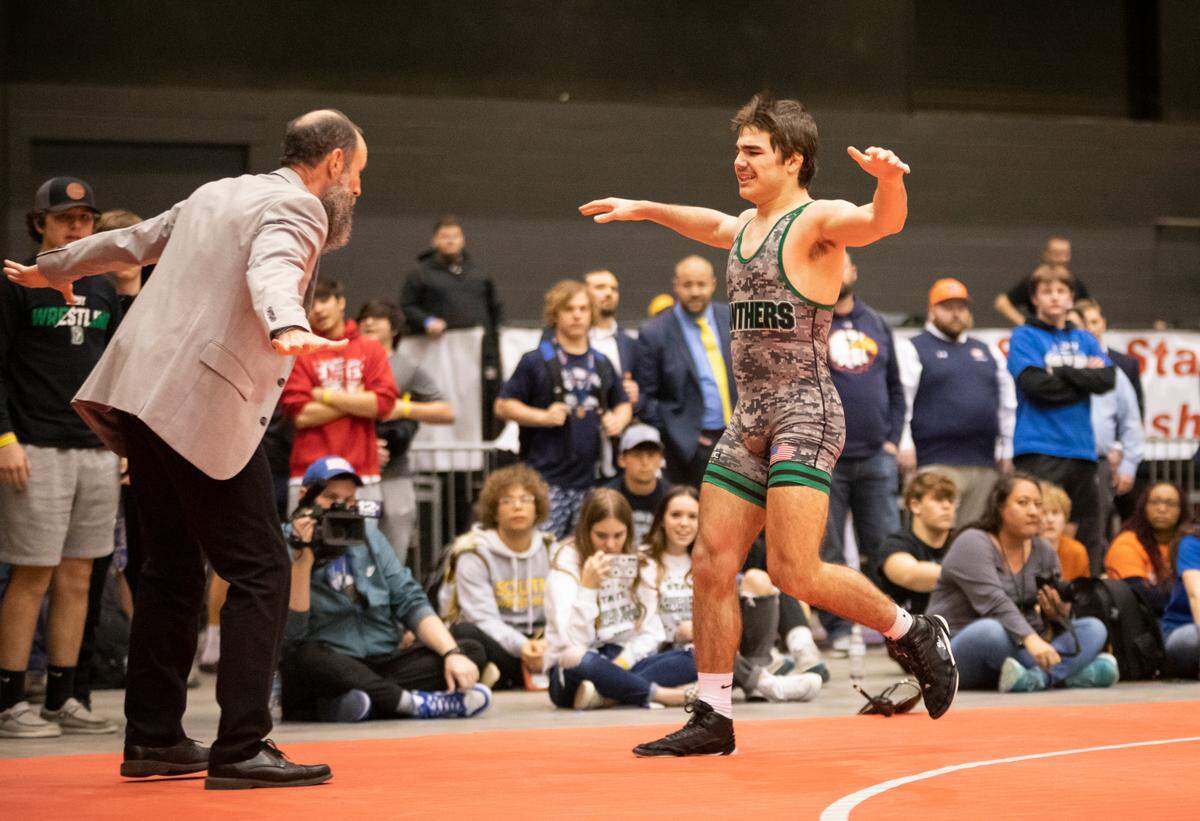 Derby’s Tate Rusher celebrates with coach Bill Ross after winning his first Class 6A state title.