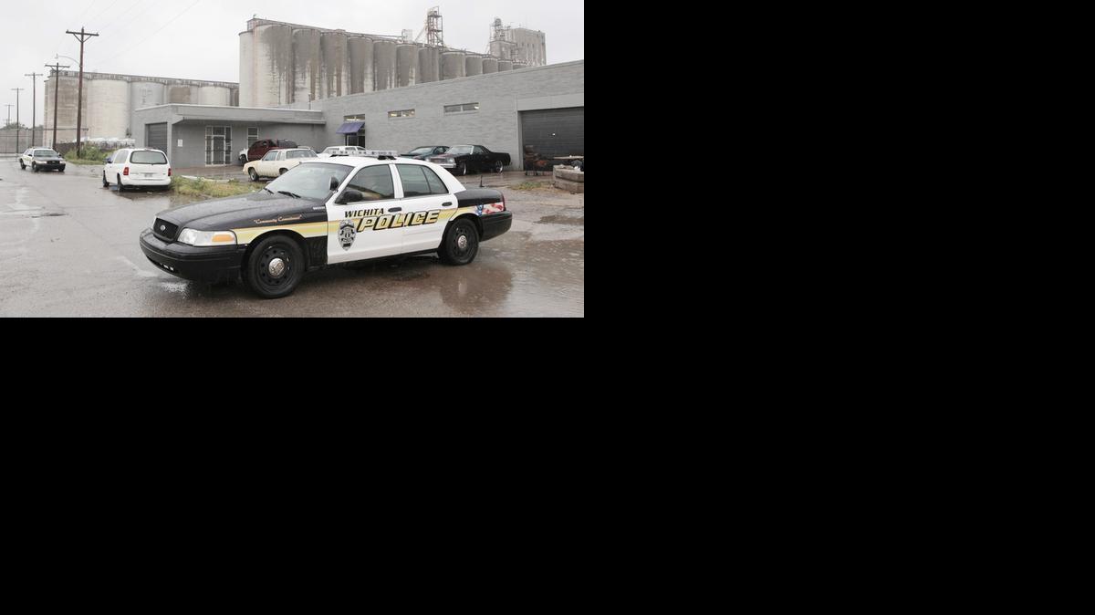 
Wichita police officers secure a crime scene near 11th and Mead July 14. One person died in the shooting and four injured. (July 14, 2013)
