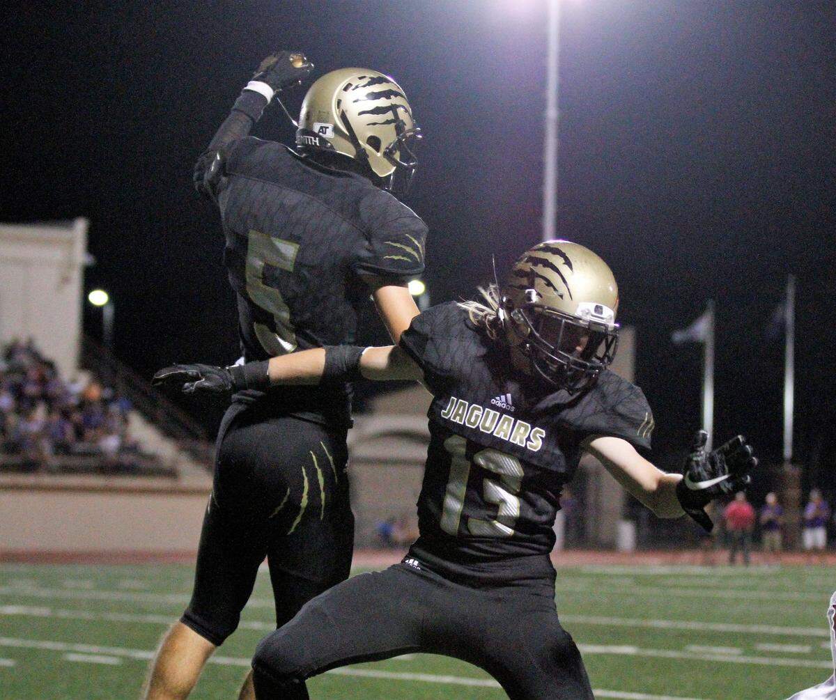 Andover Central junior receiver Matt Macy celebrates his game-clinching touchdown with junior defensive end Aaron Shellenberger on Thursday. (Sept. 20, 2018)
