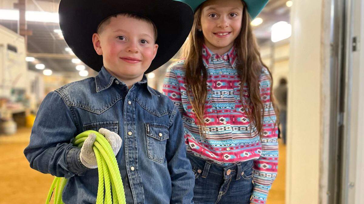 Stetson Peterson, 6, and his sister, Gracie Jo Peterson, 8, traveled from Garden City to Young Guns Extravaganza youth rodeo in Dodge City. Stetson holds the lasso he used for dummy roping, his favorite rodeo event.
