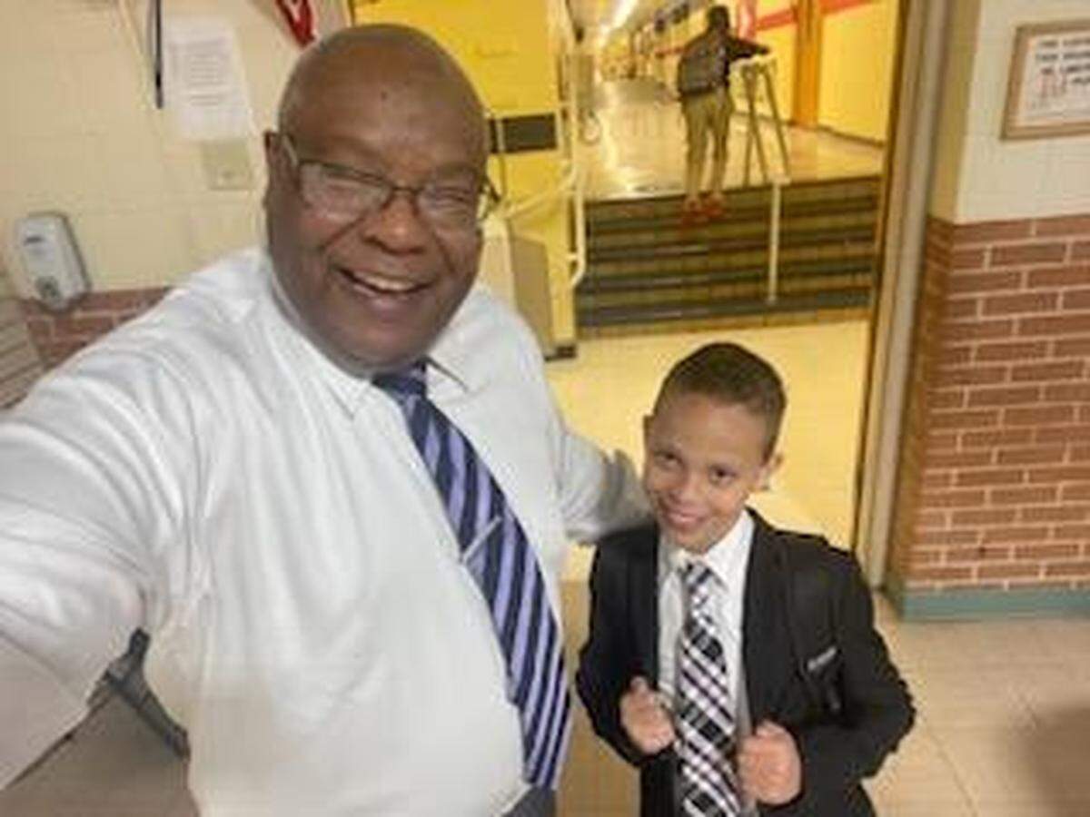 Urban Preparatory Academy Wichita founder Bishop Wade Moore with one of the school’s students.