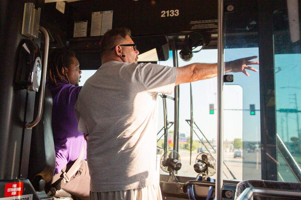 Mario White gives directions to the Social Security office to a passenger. White is an operator for Wichita transit and currently takes passengers along Rock Road.