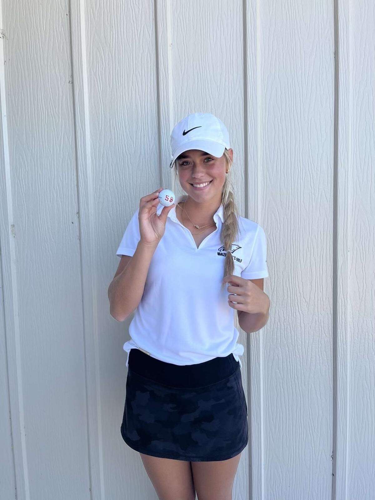 Maize senior Kinslea Jones poses with her ball after a record-setting, 13-under round of 58 at the Hesston Golf Course to win the Buhler Invitational on Friday.