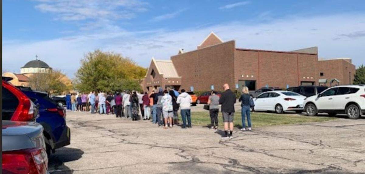 A line of voters trailed to the parking lot of Reformation Lutheran Church in east Wichita as voters waited Monday to cast their ballots.