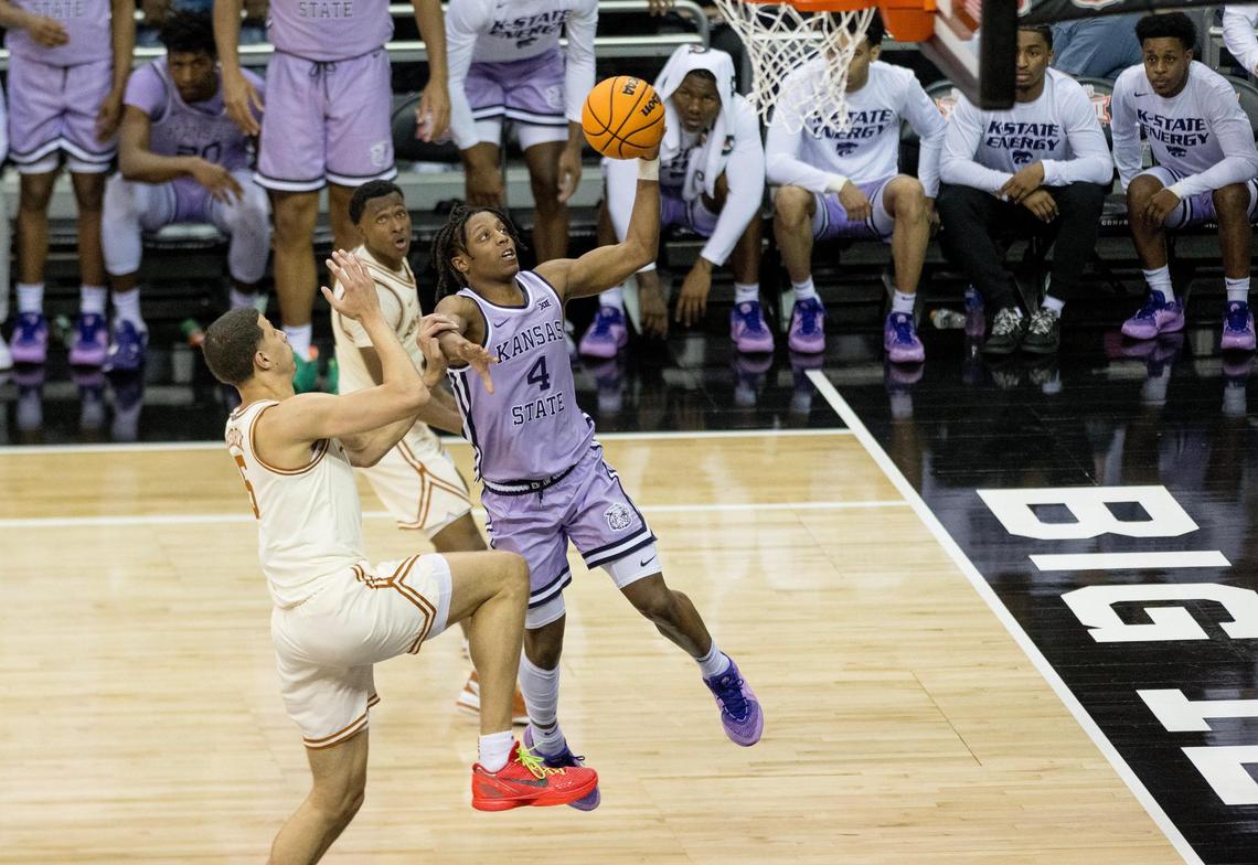 Kansas State Wildcats guard Dai Dai Ames (4) goes up for a layup as Texas Longhorns forward Kadin Shedrick (5) contests during the Big 12 men’s basketball tournament on Wednesday, March 13, 2024, in Kansas City.