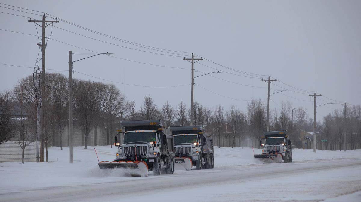A trio of snow plowers clear 135th Street West near 13th Street in this file photo. The city of Wichita announced Monday officials have named the snow plows to be used this winter to clear roads.