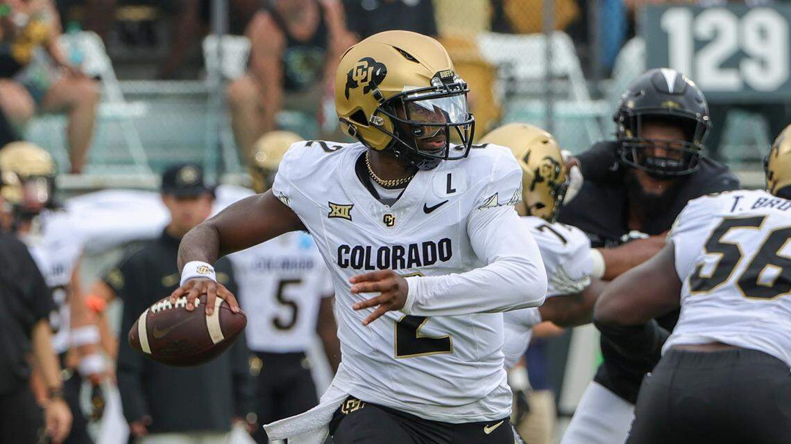 Colorado Buffaloes quarterback Shedeur Sanders (2) rolls out to pass against the UCF Knights during the first quarter at FBC Mortgage Stadium.