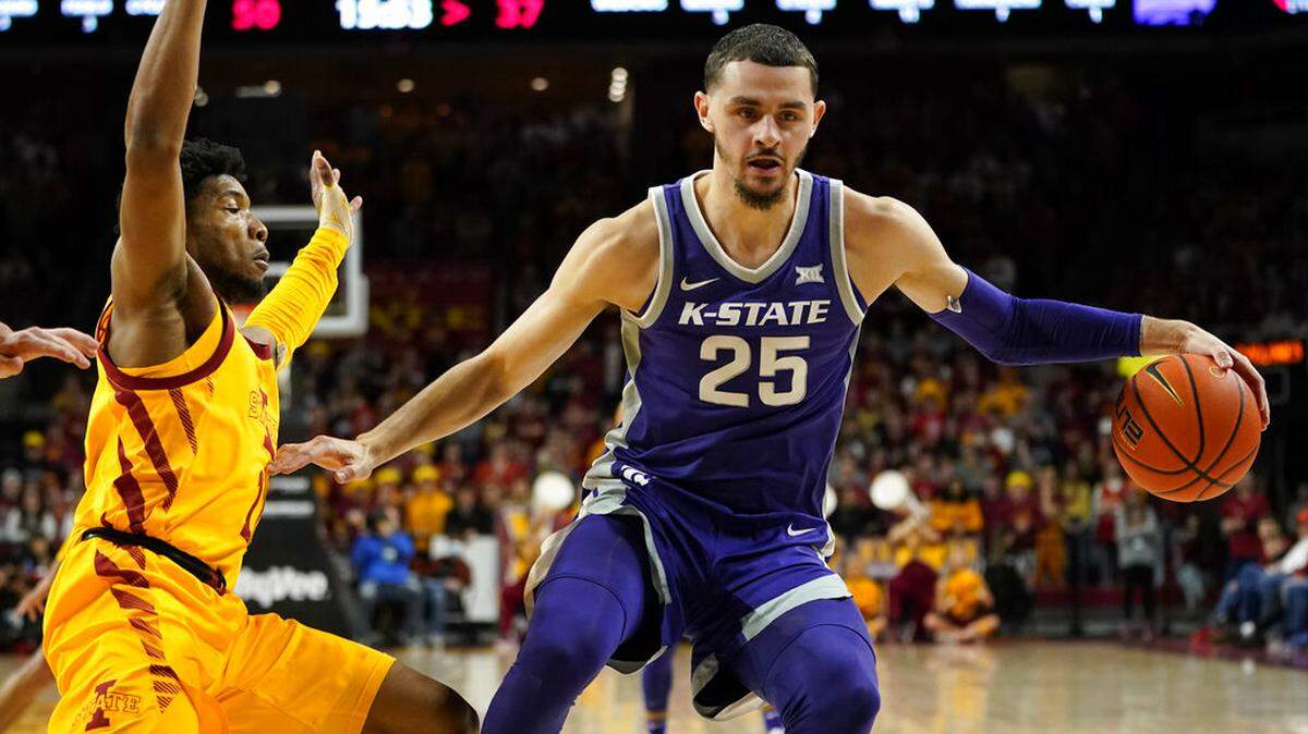 Kansas State forward Ismael Massoud (25) drives past Iowa State guard Tyrese Hunter, left, during the second half of an NCAA college basketball game, Saturday, Feb. 12, 2022, in Ames, Iowa. (AP Photo/Charlie Neibergall)