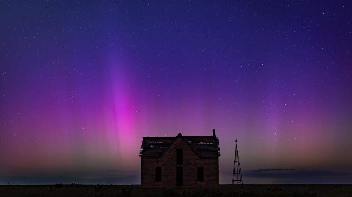 The aurora borealis can be seen in the northern sky near the Marion and Chase County line on Friday night. The abandoned stone limestone house in the pasture was built in 1878.