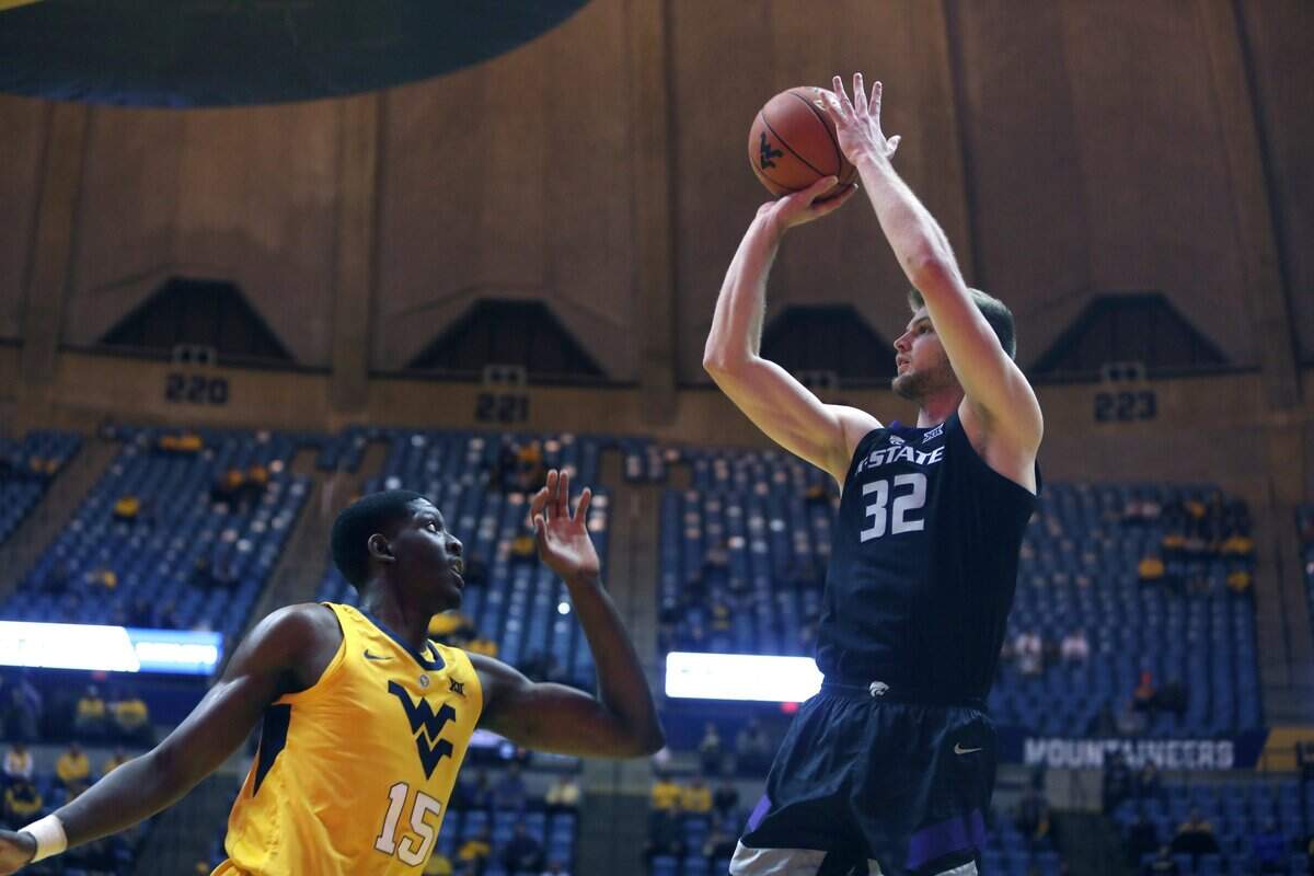 Kansas State forward Dean Wade (32) shoots while defended by West Virginia forward Lamont West (15) during the first half Monday in Morgantown, W.Va.