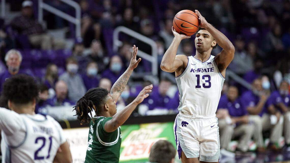 Kansas State guard Mark Smith (13) pulls up for a shot over Green Bay guard Kamari McGee (2) during the first half of an NCAA college basketball game on Sunday, Dec. 12, 2021, at Bramlage Coliseum in Manhattan, Kan. (AP Photo/Nick Krug)