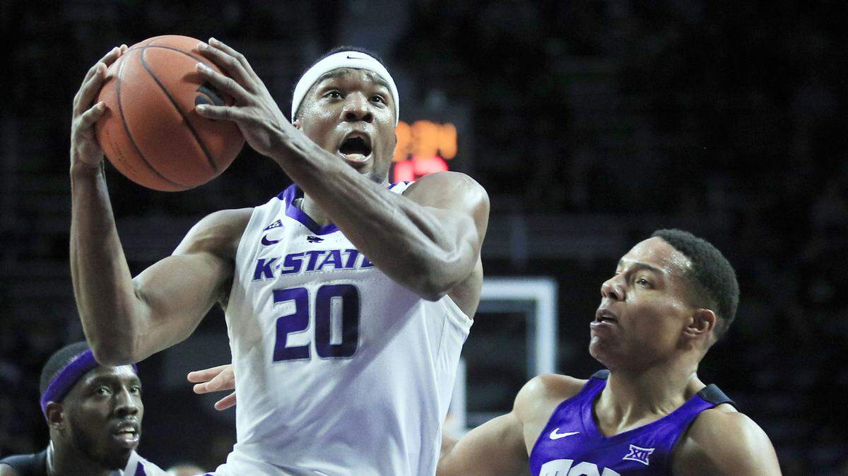 Kansas State forward Xavier Sneed (20) drives past TCU guard Desmond Bane (1) during the second half of an NCAA college basketball game in Manhattan, Kan., Saturday, Jan. 19, 2019. Sneed scored 18 points in the game. Kansas State defeated TCU 65-55. (AP Photo/Orlin Wagner)