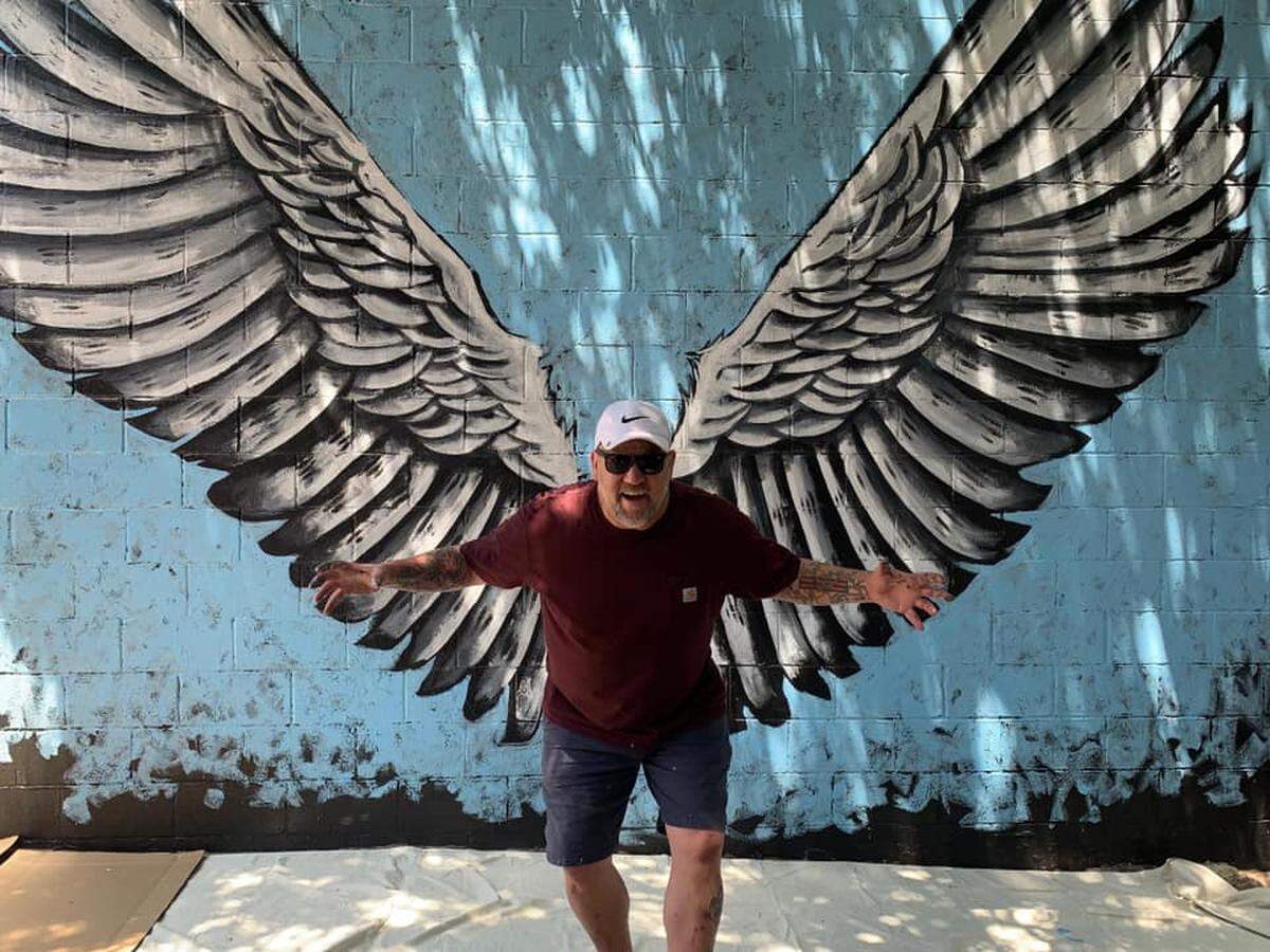 Wichita artist Mike Potts painted a pair of interactive angel wings on a south-facing wall at Wichita’s Pumphouse bar.