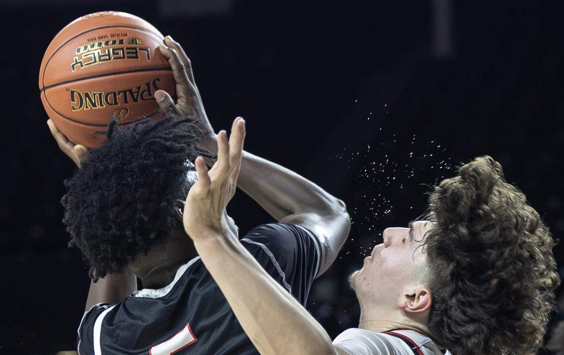 Maize’s Kingston Lerma takes an elbow from Heights’ Jordan Timmons during the first half of their quarter final game at Koch Arena on Wednesday.